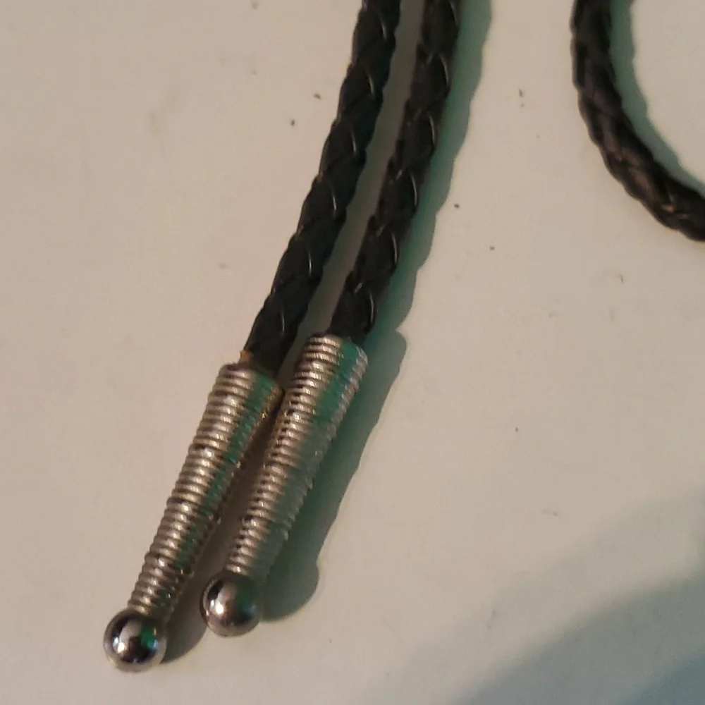 Western Bolo silver tone arrowhead with Turquoise syone on a black bread…